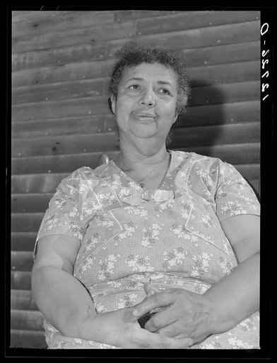 Tourist house, Truro. Portuguese woman from the Cape Verde Islands, wife of the disabled fisherman and railroad worker, now rents rooms to and boards tourists. Truro, Massachusetts