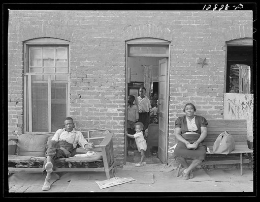 Negro family and their home in one of the alley dwelling sections. Washington, D.C.