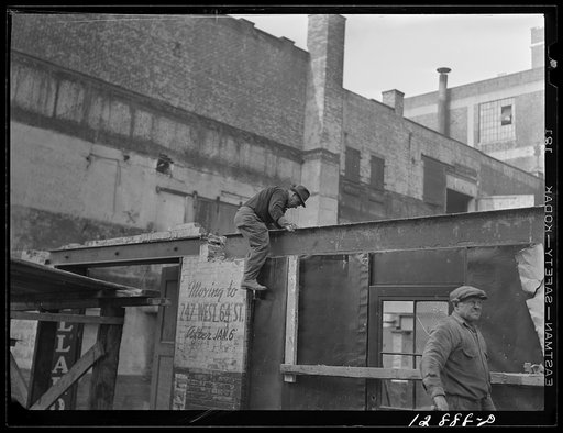 New York, New York. Workmen wrecking condemned buildings in the demolition of a slum area to make room for a housing project