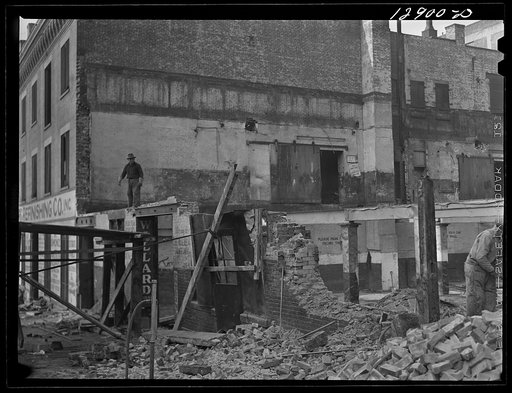 New York, New York. Workmen wrecking condemned buildings in the demolition of a slum area to make room for a housing project