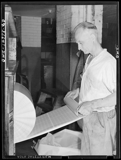 Washington, D.C. Inspecting a postage stamp roll for proper gumming at the United States Bureau of Engraving and Printing