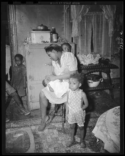 Washington, D.C. A mother getting the children ready for a neighborhood birthday party