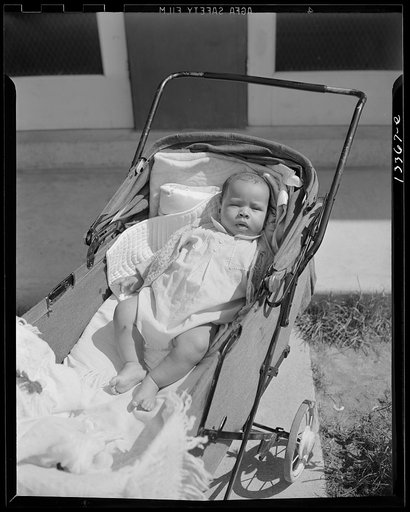 Anacostia, D.C. Frederick Douglass housing project. Baby taking a sun bath