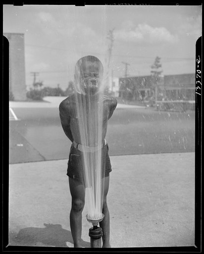 Anacostia, D.C. Frederick Douglass housing project. Playing in the community sprayer