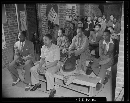 Washington, D.C. Air raid wardens' meeting in zone nine, Southwest area. Air raid wardens attending a meeting in their headquarters which is provided by the landlord in the basement of a large apartment building