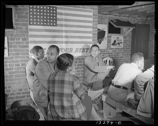 Washington, D.C. Air raid wardens' meeting in zone nine, Southwest area. Air raid wardens listening to a report by one of the wardens at a meeting in their zone headquarters