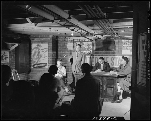 Washington, D.C. Air raid wardens' meeting in zone nine, Southwest area. Elmer House, federal worker by day and an air raid warden at night, outlining plans for his sector