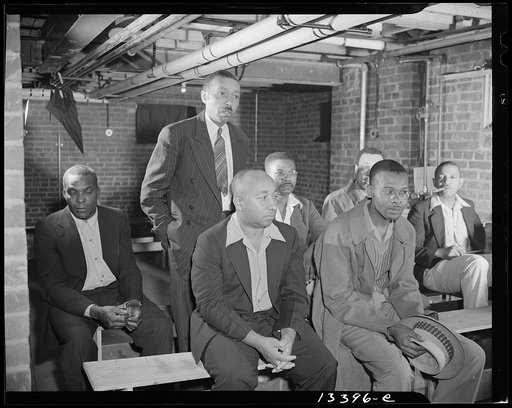 Washington, D.C. Air raid wardens' meeting in zone nine, Southwest area. Mr. Barton, a sector warden, reporting to the chairman and other wardens on his sector activities for the week