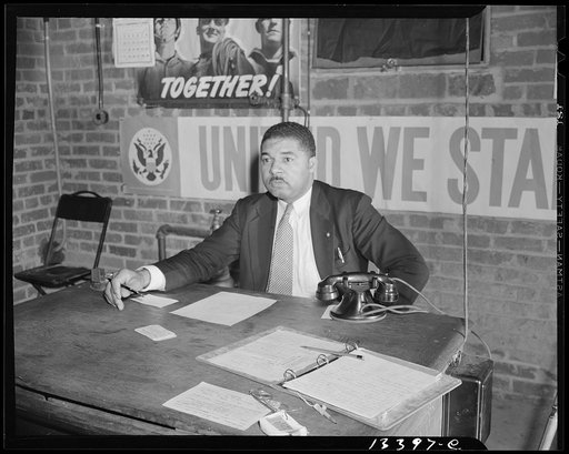 Washington, D.C. Air raid wardens' meeting in zone nine, Southwest area. Mr. Douglas Frederick, who is a firewatcher at the hotel where he is employed and a deputy warden in his neighborhood, presiding at a meeting of the wardens