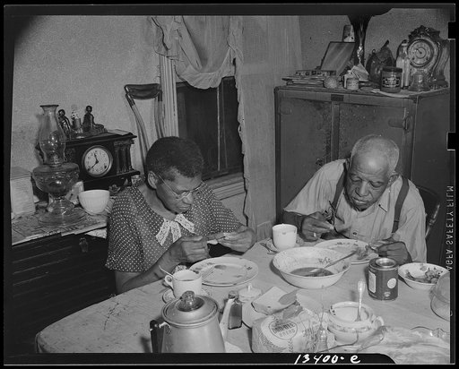 Washington, D.C. Elderly couple eating dinner at their home on Lamont Street, N.W.