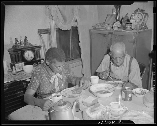 Washington, D.C. Elderly couple eating dinner at their home on Lamont Street, N.W.