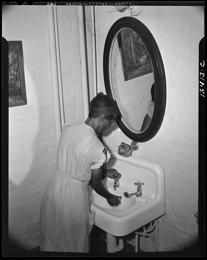 Washington, D.C. Government charwoman cleaning offices. Her working hours are from 5:30 till 1 a.m.