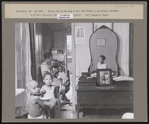 Washington, D.C. Dinner time at the home of Mrs. Ella Watson, a government charwoman