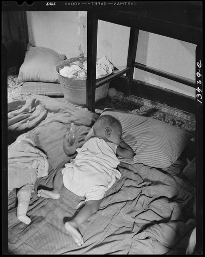 Washington, D.C. Grandchild of Mrs. Ella Watson, a government charwoman, taking her afternoon nap