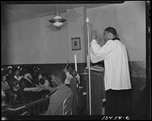 Washington, D.C. Reverend Vondell Gassaway, pastor of the St. Martin's Spiritual Church, preaching. Mrs. Ella Watson, a government charwoman, is a member of the church