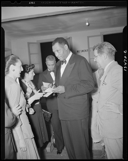 Washington, D.C. Russian war anniversary benefit at the Watergate. Paul Robeson and autograph hunters backstage