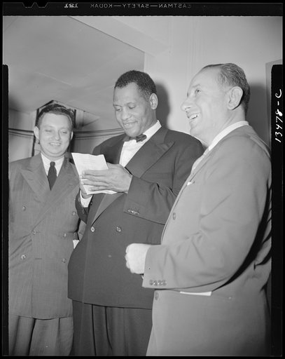 Washington, D.C. Russian war anniversary benefit at the Watergate. Paul Robeson and autograph hunters backstage