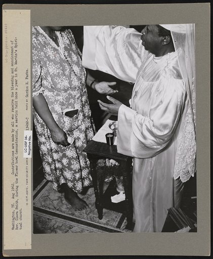 Washington, D.C. Contributions are made by all who receive the blessing and annointment of Rev. Clara Smith, during the Flower bowl demonstration, a service held once a year in St. Martin's Spiritual church