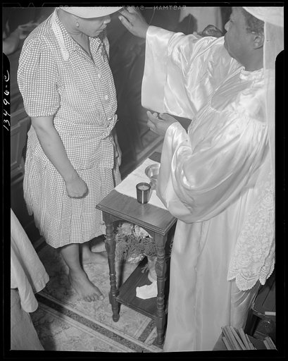 Washington, D.C. Reverend Clara Smith anointing a member of the St. Martin's Spiritual Church during the annual "flower bowl demonstration" service