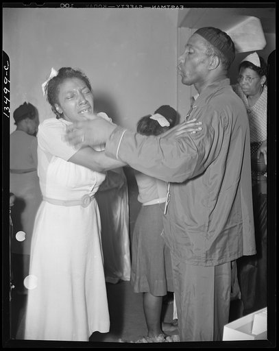 Washington, D.C. A member of the St. Martin's Spiritual Church, receiving the final blessing of a flower from Reverend Vondell Gassaway, the pastor at the annual "flower bowl demonstration"