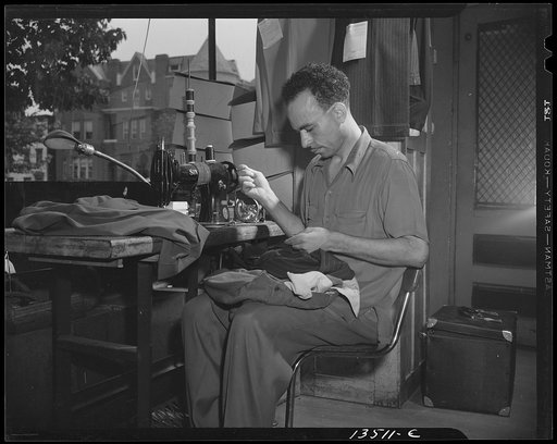 Washington, D.C. A tailor in Frank's cleaning and pressing establishment altering a pair of pants for a customer
