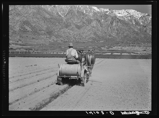 C.E. Toombs, Cache County, Utah, Farm Security Administration rehabilitation client, drives a new tomato planting machine bought with part of a Farm Security Administration loan