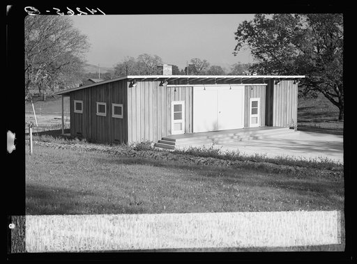 Sonoma, California. Farm Security Administration camp for migratory agriculture workers. Wooden community building and concrete platform