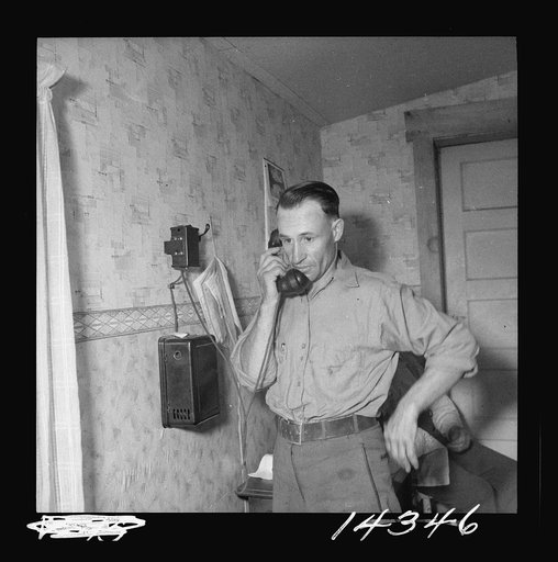 Earl Cazier, manager of St. Anthony stud service, receives call for bull. Fremont County, Idaho