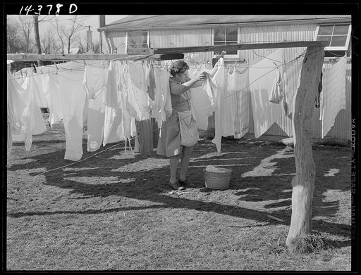 Wife of defense worker hanging out wash in trailer camp on Mount Vernon Highway near Alexandria, Virginia