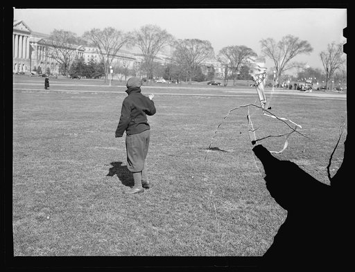 Boy playing with kite in front of Washington Monument. Washington, D.C.