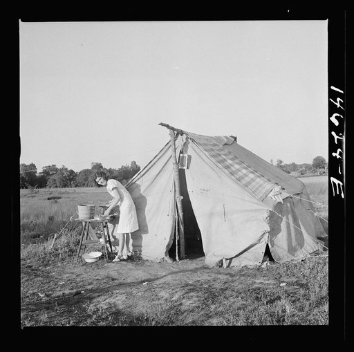The Harry Stanfords, living in a makeshift tent in the same spot where their new trailer is parked now. Childersburg, Alabama
