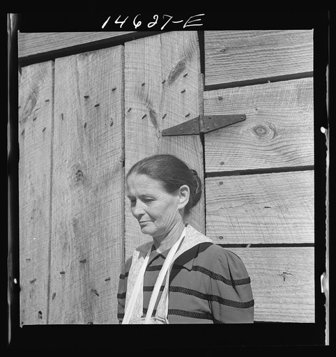 Mrs. Fisher has to set up a boardinghouse everywhere she goes to make ends meet, for she has a family of seven to feed. The small house they rent here has six rooms and they have six roomers. Others stay in a cabin built in the backyard. All use the single bath. Childersburg, Alabama
