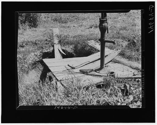 Milaca, Minnesota. Well pit eliminated by installation of pipe and water pump