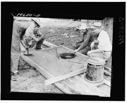 Placing concrete in form for privy slab. Minnesota