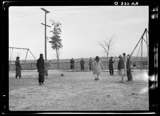 Untitled photo, possibly related to: Row of identical houses off Eastern Avenue, in Cincinnati, Ohio, showing backyard outhouses. Ohio River Valley is in the distance