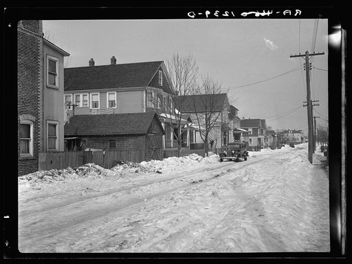Untitled photo, possibly related to: Garage in foreground is home of white family, man and wife. Manville, New Jersey