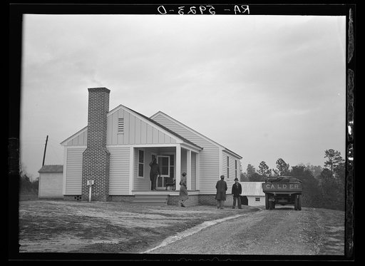 Untitled photo, possibly related to: Mr. William Howard supervises the men moving his household goods into a new house at Gardendale, Alabama