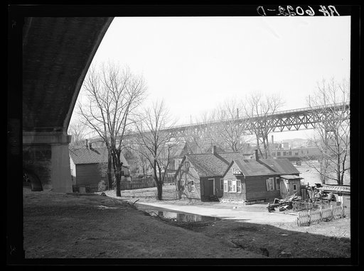 Untitled photo, possibly related to: Housing under Wisconsin Avenue viaduct. Milwaukee, Wisconsin