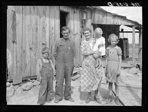 Untitled photo, possibly related to: Part of John Cain family who live in this three-room house near Ashland, Missouri. University of Missouri game and arboretum project