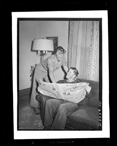Untitled photo, possibly related to: Vernon County, Wisconsin. Robert and a hired man discussing news in the parlor after dinner