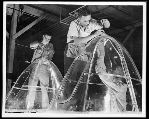 Untitled photo, possibly related to: Manpower. Negro bomber plant workers. American manpower draws its skills from various racial groups alike. Here, in a large Eastern bomber plant, huge transparent plastic bomber noses are being conditioned for installation on planes which will carry America's off