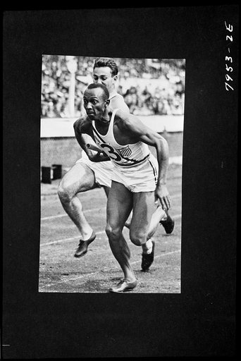 Untitled photo shows: Jesse Owens and teammate competing in the 400 meter relay at the Berlin Olympics, 1936