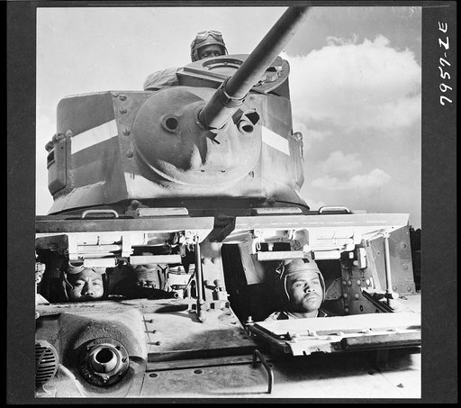 Untitled photo shows: Goliaths of modern warfare. These men make up the crew of one of American's most modern tanks