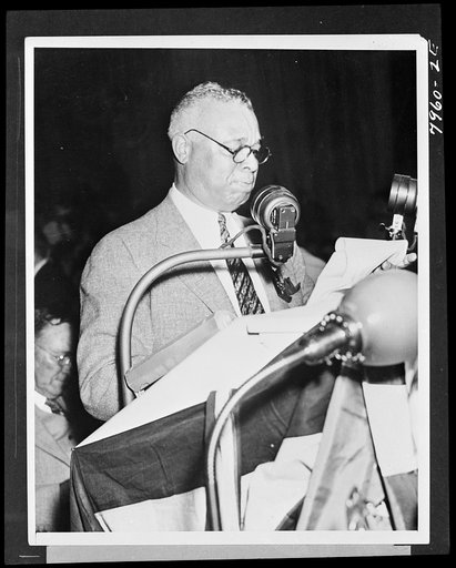 Untitled photo shows: Representative Arthur W. Mitchell, of Chicago, snapped as he spoke at the Democratic National Convention in Philadelphia, PA, June 25. For the second time, Senator Ellison D. Smith of South Carolina, bolted the convention when a Negro was recognized from the floor. Two other me