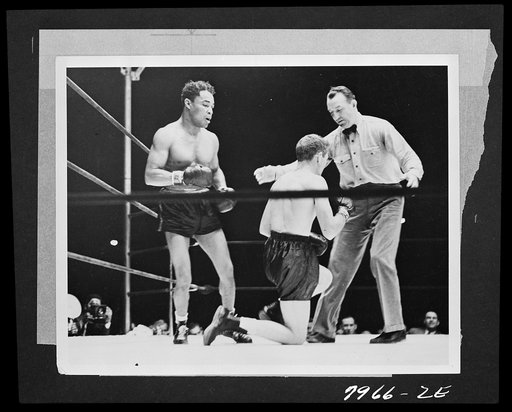 Untitled photo shows: Henry Armstrong, boxing champion, with his opponent Lew Jenkins and referee Arthur Donovan at the Polo Grounds, New York