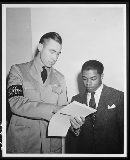 Untitled photo shows: William Baldwin, June 1942. Baldwin was the first U.S. Navy African American recruit being assisted by a U.S. Navy Recruiting Service member, June 2, 1942