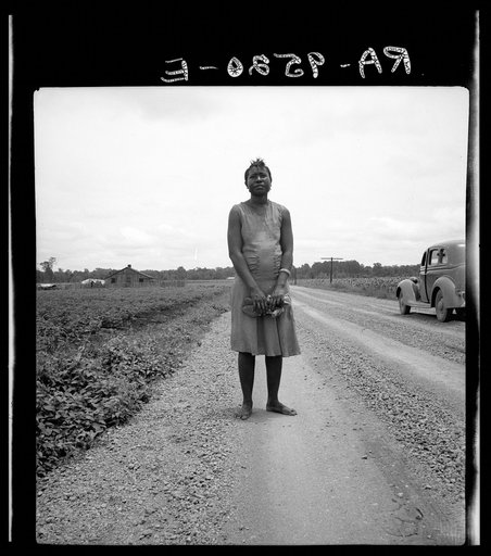 Untitled photo, possibly related to: Negro woman carrying her shoes home from church. Mississippi Delta