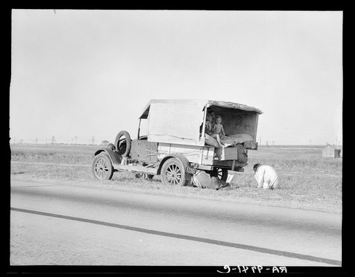 Untitled photo, possibly related to: Family between Dallas and Austin, Texas. The people have left their home and connections in South Texas, and hope to reach the Arkansas Delta for work in the cotton fields. Penniless people. No food and three gallons of gas in the tank. The father is trying to re