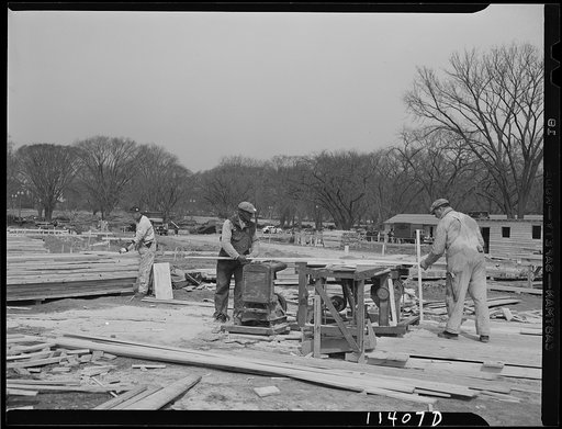 Untitled photo, possibly related to: Washington, D.C. Construction of temporary war emergency buildings on the Mall, near 16th and 17th Streets, N.W. Carpenter nailing the form of a concrete foundation