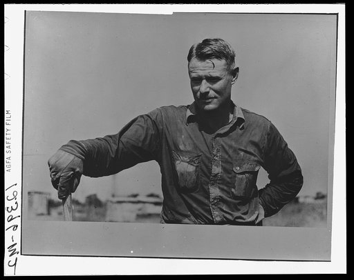 Roustabout in the ditch-digging crew. Notice the sweated shirt. Seminole oil field, Oklahoma